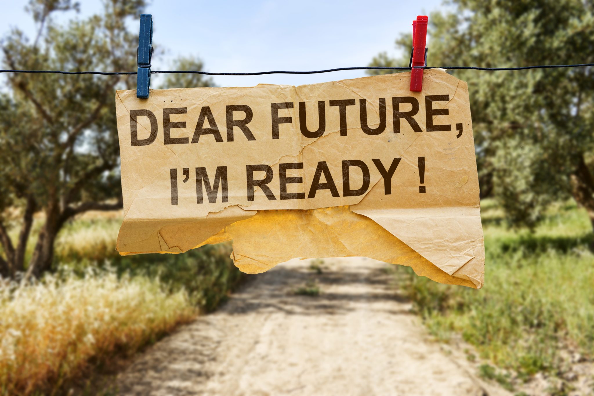 hanging tear paper with dear future i’m ready ! concept near blurred olives field background